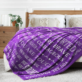 SteadStyle Get Well Blanket on couch for casual comfort.