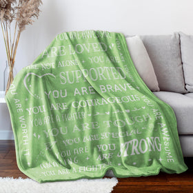 SteadStyle Get Well Blanket shown in a cozy living room setting.