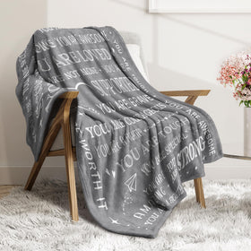SteadStyle Get Well Soon Blanket draped on a sofa for coziness.