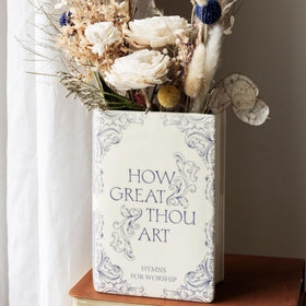 Decorative vase used as an office organizer with pens and scissors