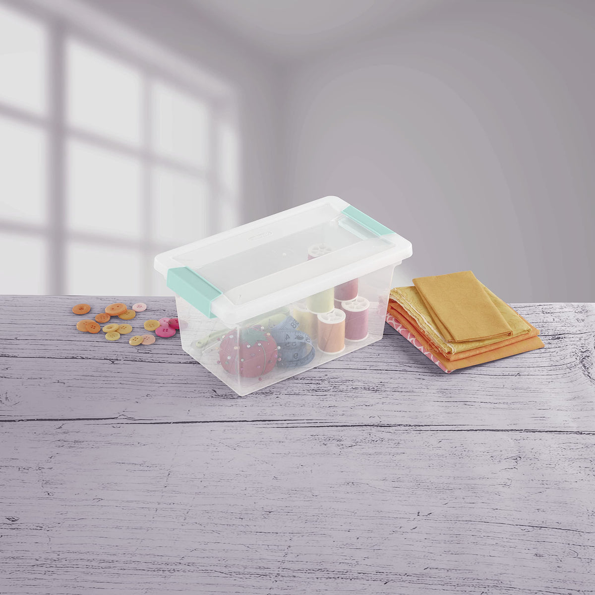 Sterilite clip box in office or craft setup helps organization.