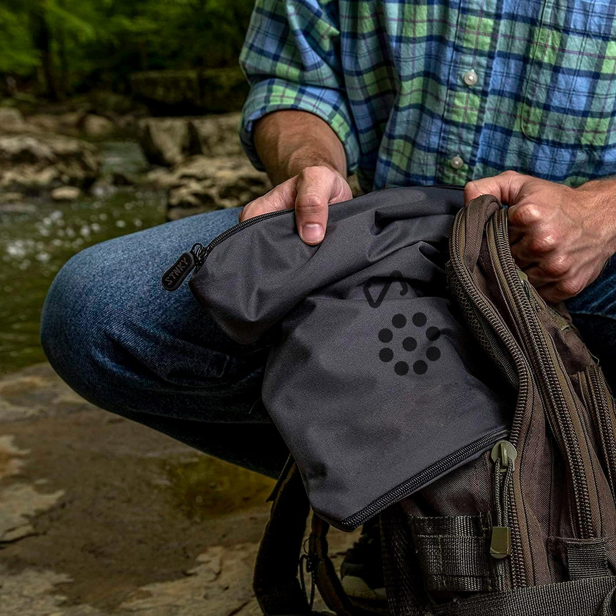 STNKY Bag Pro muddy gear containment scene highlights mess-free environments.