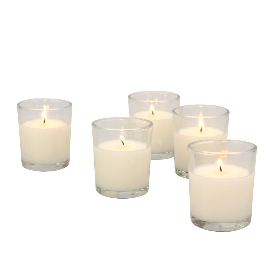 Stonebriar 48-pack unscented votive candles on a table, creating a warm ambiance.