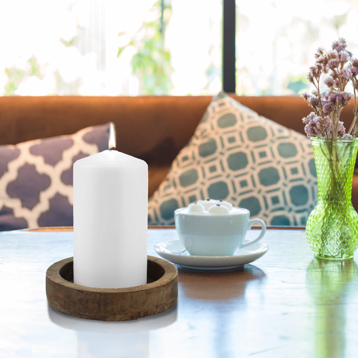 Stonebriar pillar candle glows warmly on the fireplace mantel.