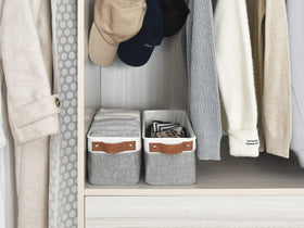 StorageWorks narrow bin in a laundry area, supporting folded laundry and small items.