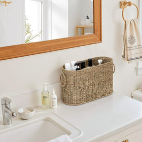 StorageWorks toilet paper storage beside sink offers accessible organization