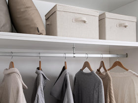 StorageWorks large bin used for towels, organized in a linen closet.
