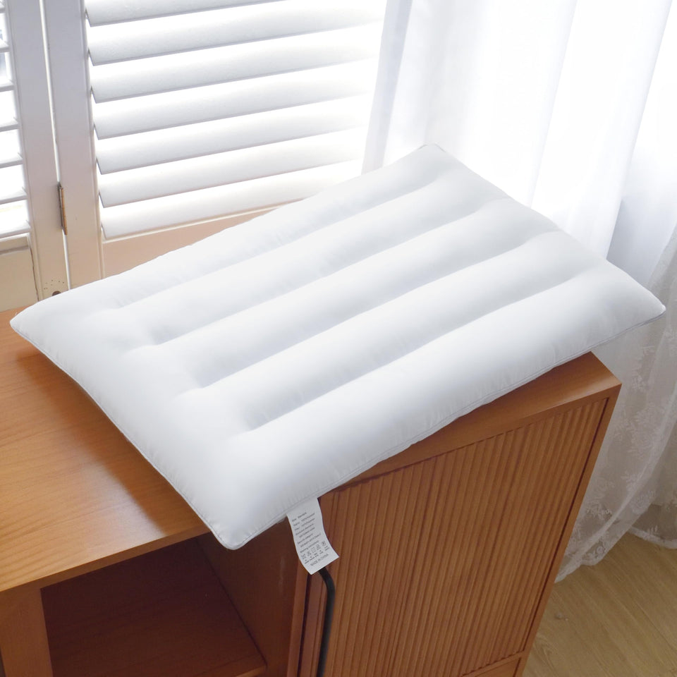 Suhedy Thin Pillow front view on bed supports neck and back alignment