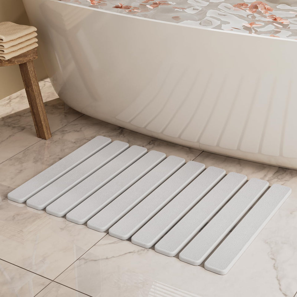 Summer&Kiss foldable stone bath mat with absorbent surface for fast drying.