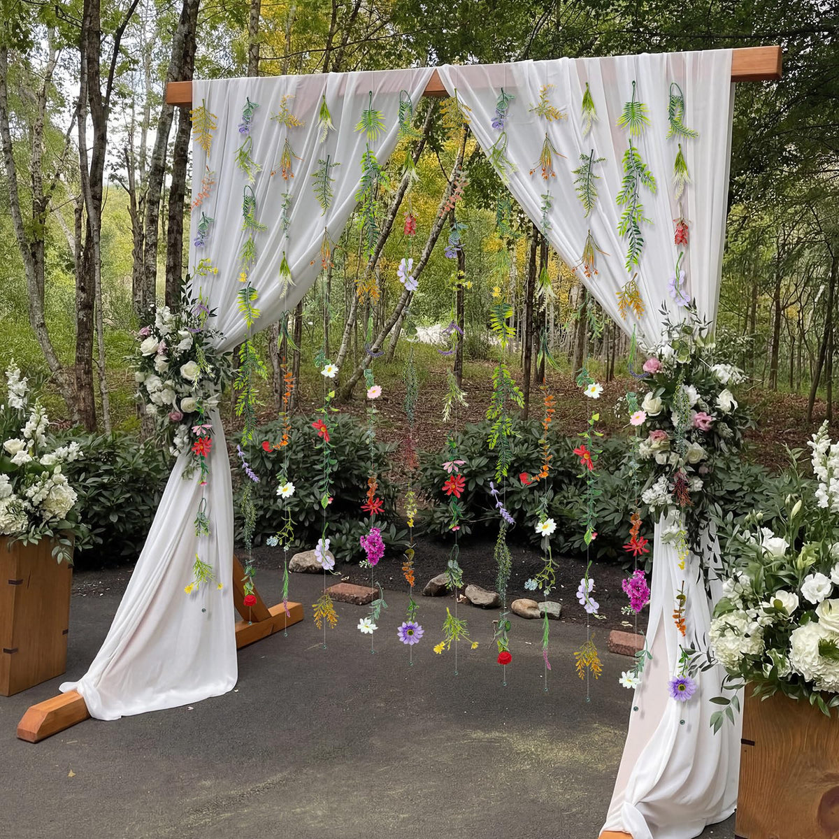 Suncalla wedding arch garland in multicolor florals for vibrant themes.