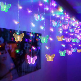 SunKite butterfly curtain lights over a window add a warm, twinkling ambiance.