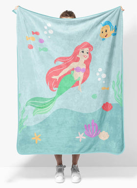 Sunny Side Up Disney Little Mermaid blanket shows Ariel and Flounder for cozy travel comfort.