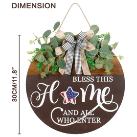 Super Holiday welcome sign with green plants and bows adds seasonal charm