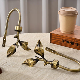 SUQ I OME 2-pack brass curtain holdbacks simplify window styling.