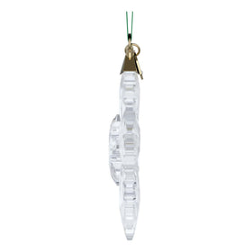 Swarovski snowflake pendant hangs from a green grosgrain ribbon.
