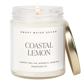Sweet Water Decor Coastal Lemon candle in a clear jar with gold lid for a fresh coastal aroma.