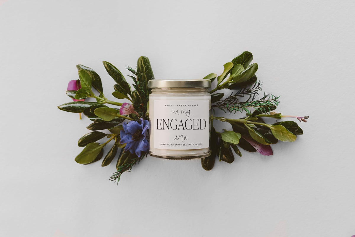 Sweet Water Decor Engaged Era Candle lid adds a touch of elegance to the display.