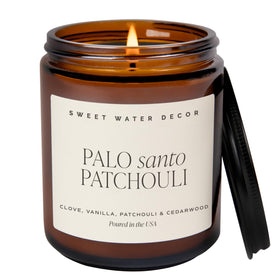 Sweet Water Decor Palo Santo Patchouli candle in amber jar creates warm ambiance.