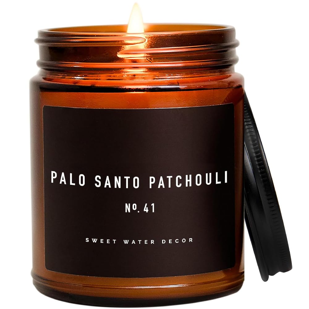 Sweet Water Decor Palo Santo Patchouli Candle in amber jar creating a warm, inviting atmosphere.