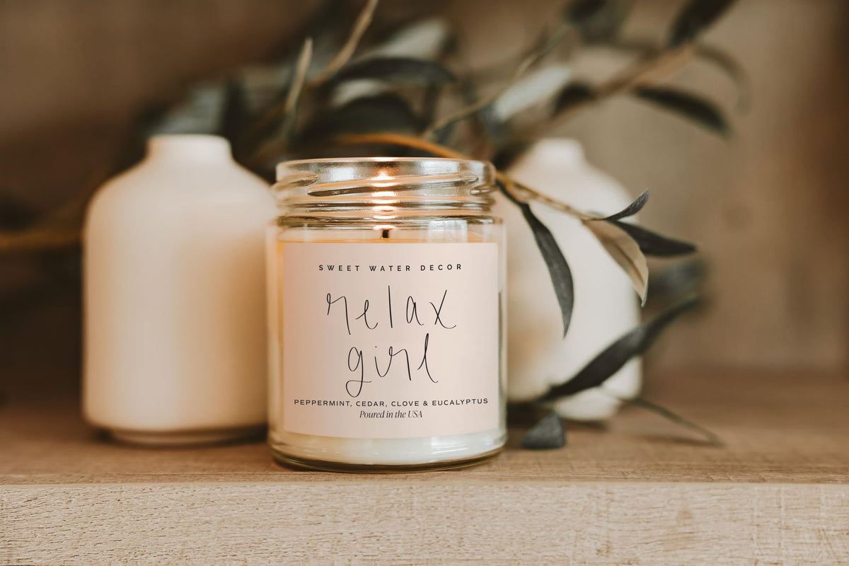 Sweet Water Decor Relax Girl on wood table evokes cozy living vibe.