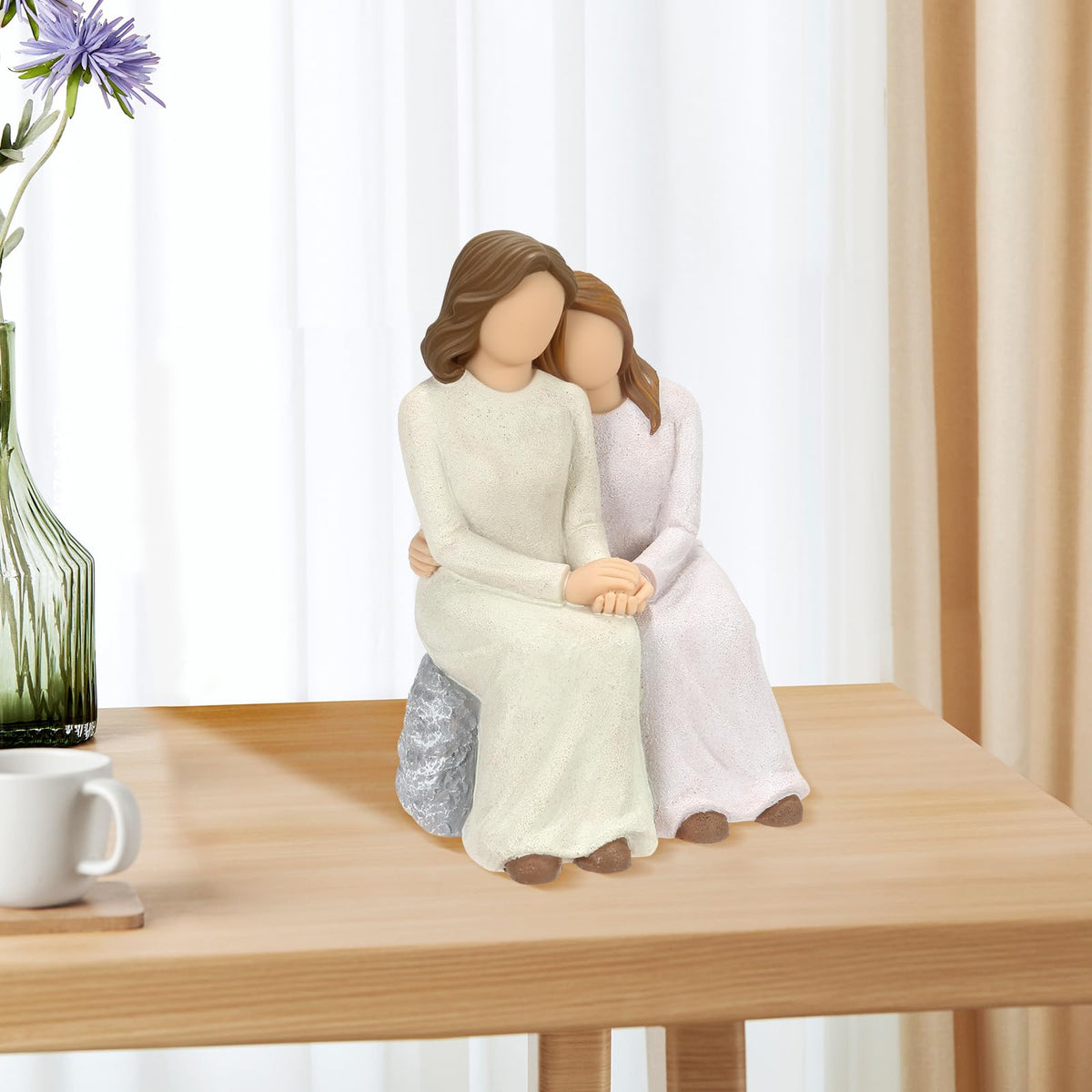 Symbullize hand-painted figurine with delicate dress details and gentle hand-hold.