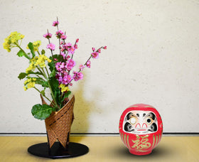 Takasaki Daruma red doll, side view, handcrafted in Takasaki's workshop.