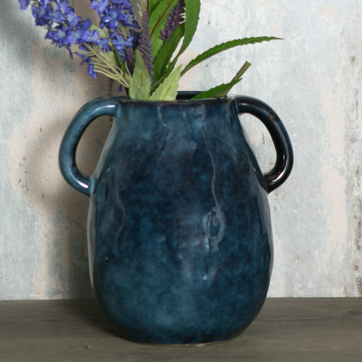 Tanvecle blue ceramic vase with two handles, ideal for a striking centerpiece.