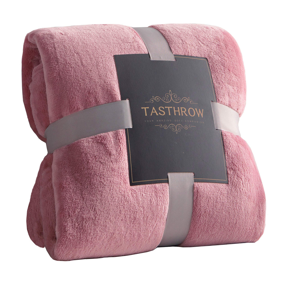 TASTHROW large pink flannel fleece throw on sofa for cozy lounging.