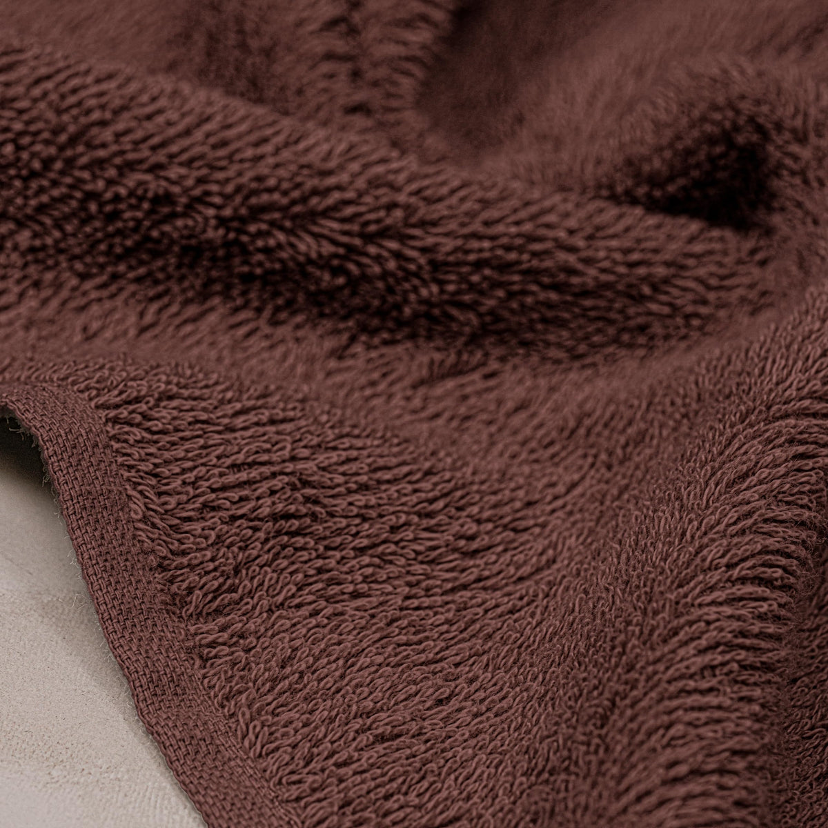 Tens Towels 100cotton-brown-hand-towels-flatlay emphasizes softness.