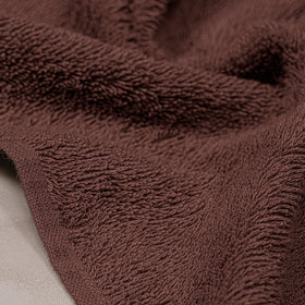 Tens Towels 100cotton-brown-hand-towels-flatlay emphasizes softness.