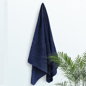 Tens Towels navy bath sheet draped over chair for lounging