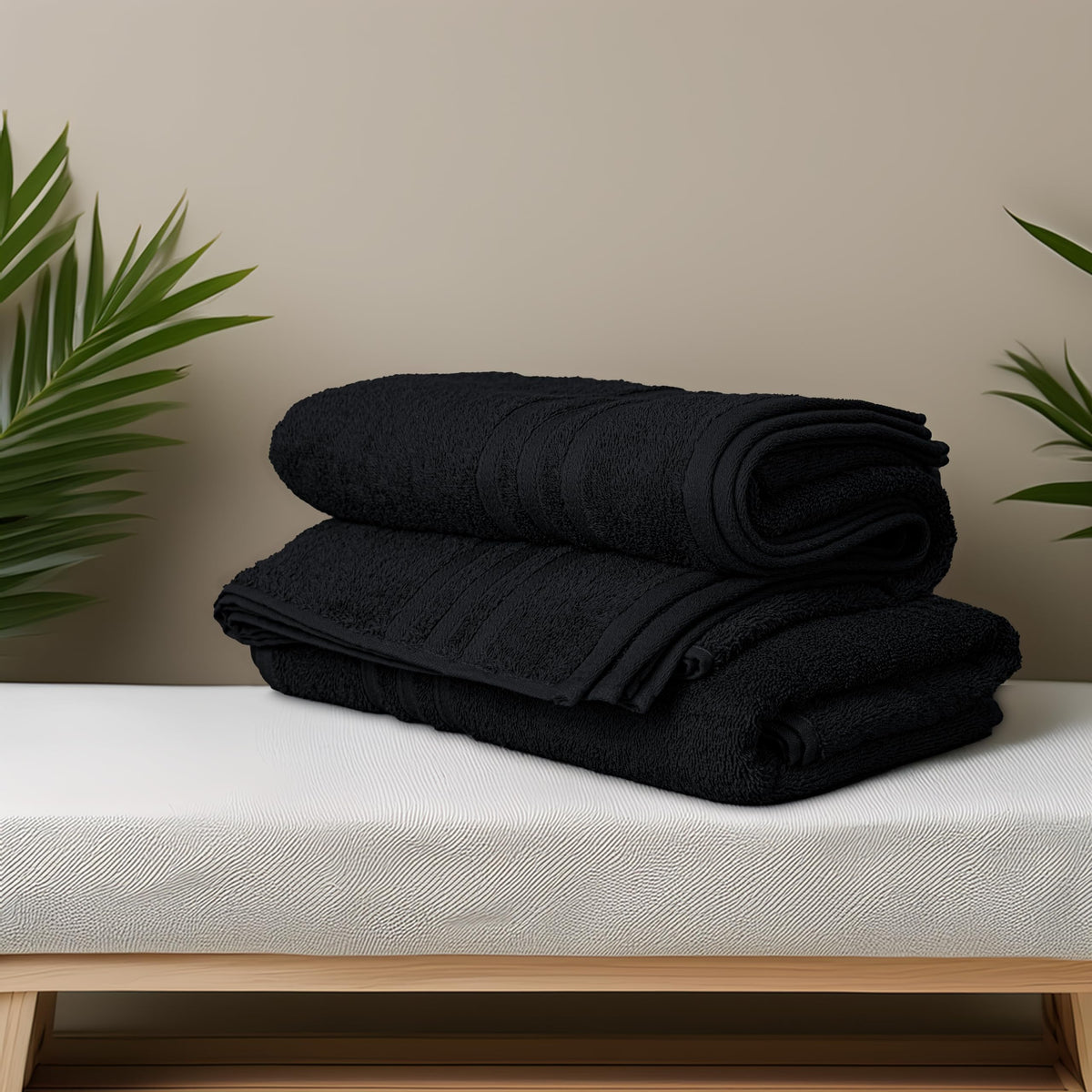 Tens Towels black bath towels folded on a rack