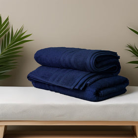 Tens Towels navy bath towels on rack showcasing plush softness and quick-dry design.