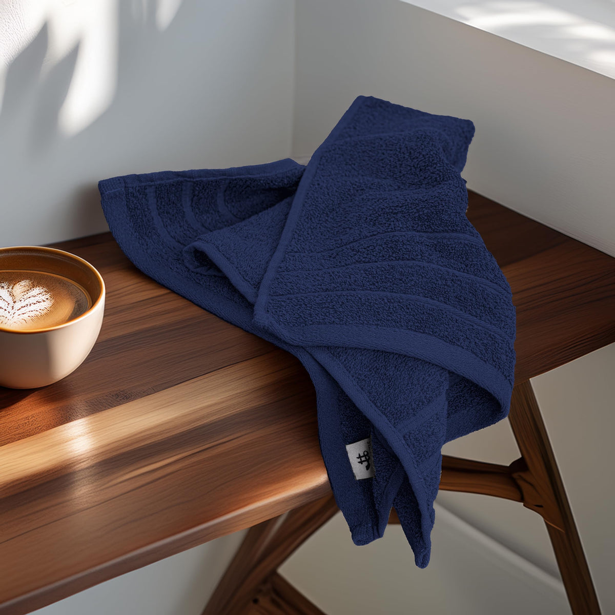 Tens Towels navy hand towels displayed in bathroom scene for daily drying.