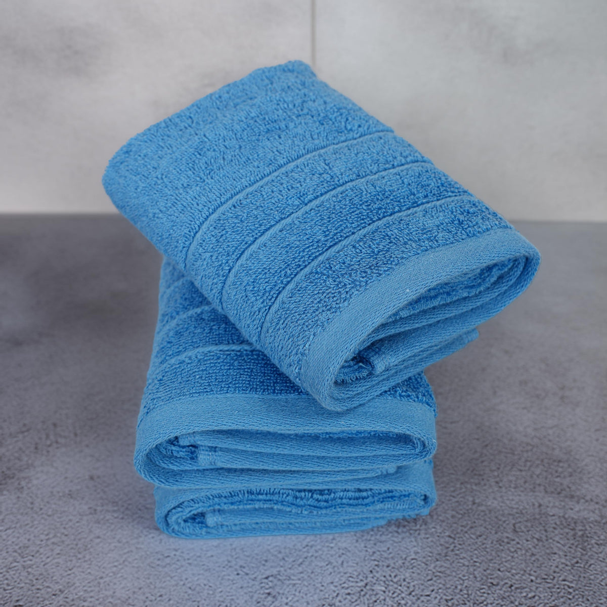 Tens Towels blue towels in a bathroom setting demonstrate lightweight fast-drying design