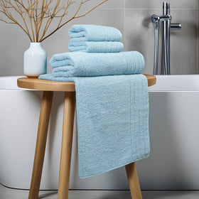 Tens Towels sky blue tone complements modern bathroom.