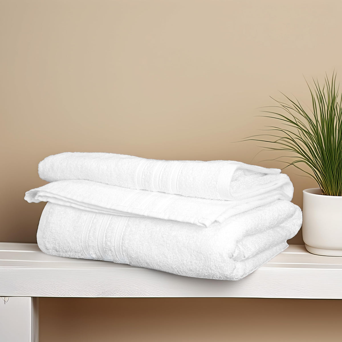 Tens Towels white bath towel pile ready for bathroom storage.