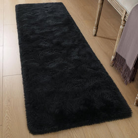Tepook black fluffy rug beside the bed offers warm mornings