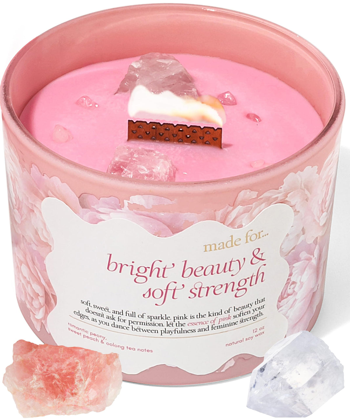 The Mindful Collective pink crystal candle closeup with soft glow for calming ambience.