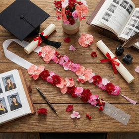Thiccywoov Graduation Lei neckwear worn diagonally with gown for a refined look.
