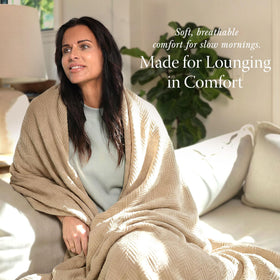 Threadmill king-size blanket draped over bed for cozy ambiance.