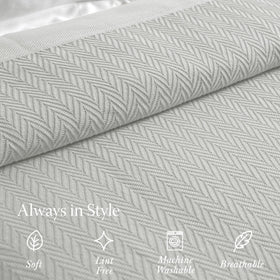 Threadmill blanket draped on a couch highlights versatile home use and style