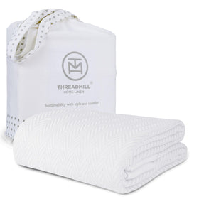 Threadmill luxury cotton blanket on a queen bed offers cozy softness for all-season comfort.