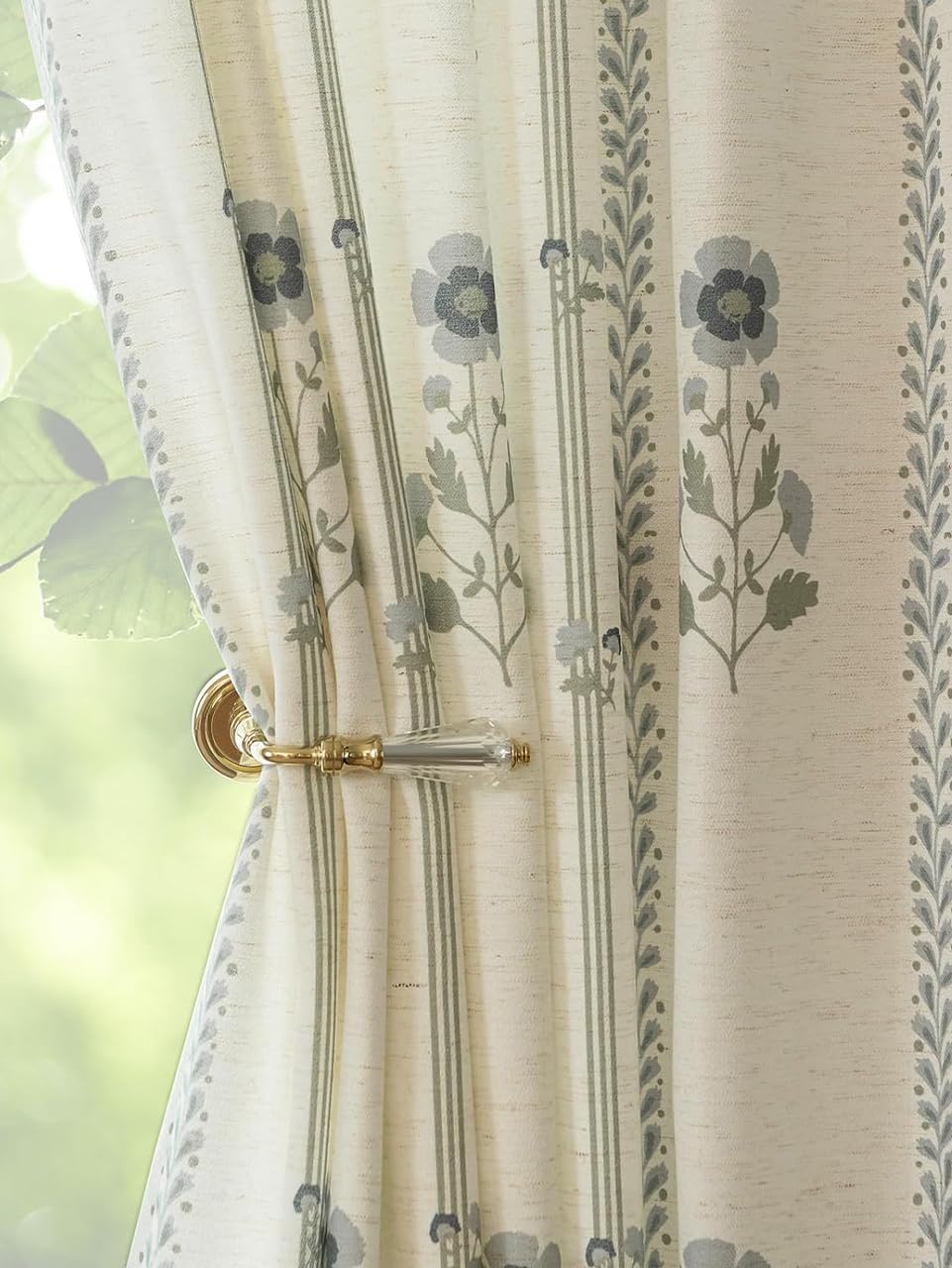 Three Girls pinched-pleat curtains frame a living room with elegant privacy and soft light