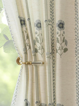 Three Girls pinched-pleat curtains frame a living room with elegant privacy and soft light