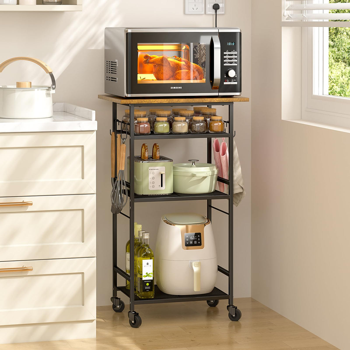 ThreeHio rolling microwave cart with four-tier shelves for compact kitchen storage.