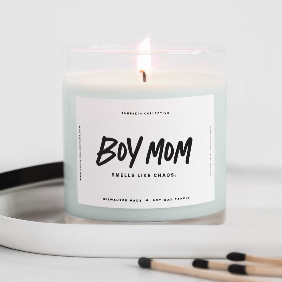 ThreeKin Collective candle label close-up showing Smells Like Chaos for moms.