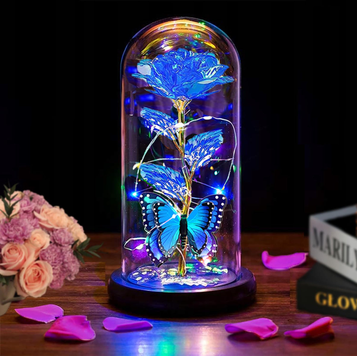 Thrjia blue LED rose in glass dome lights up for romantic ambiance.