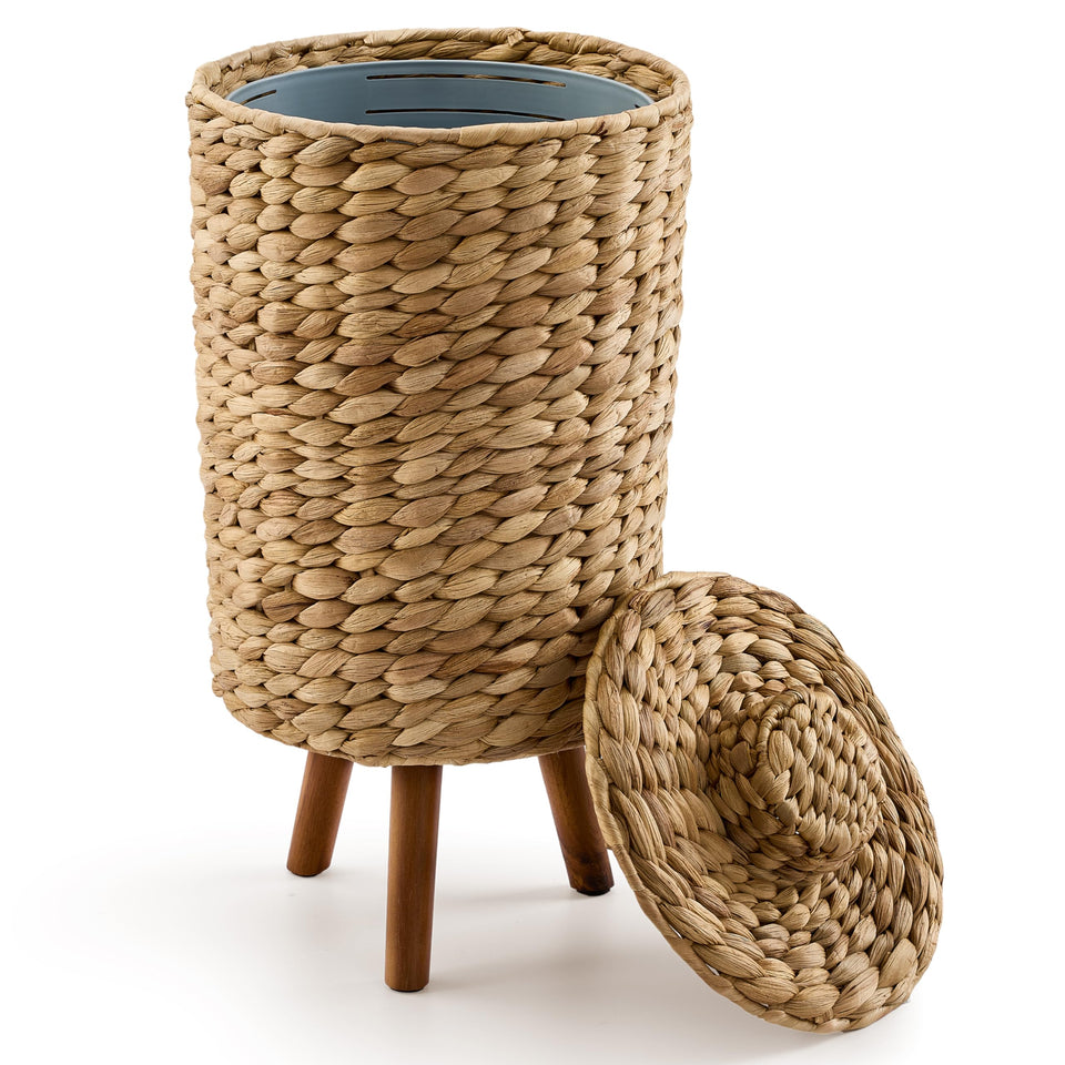 Tidita wicker trash can with lid and wooden legs discreetly organizes bathroom waste.