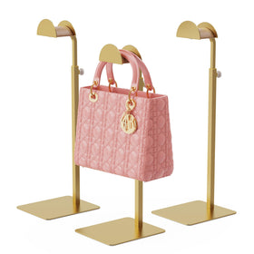TIPSYTREE purse display stand in gold finish keeps handbags organized on shelves.